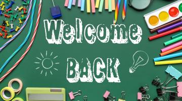 Image shows a green welcome back sign with different bits of stationery around the sides including pencils and paint