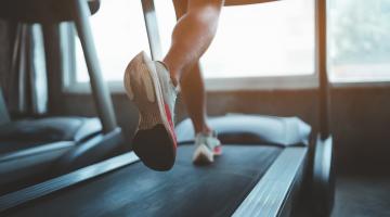 Image shows a woman's feet running on a treadmill