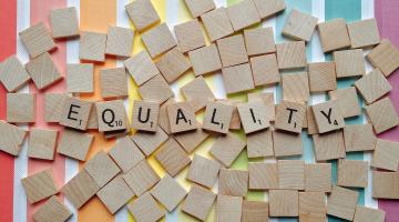 A photograph spelling the word 'equality' using scrabble pieces