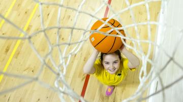 A school pupil playing basketball