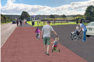 Image shows the proposed active travel route with different users. They include a male pushing his child on a balance bike, a cyclist and a lady pushing a wheelchair user. 