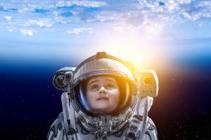 Image shows a child in a spacesuit 