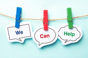 Image shows three pegs on a line holding the words we can help