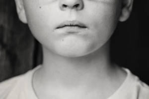 Image shows a child's face in black and white 