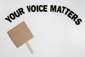 A placard with the words your voice matters above it.