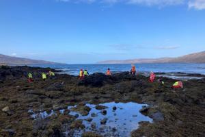 Image shows children from Ulva Primary School enjoying their outdoor classroom on the shoreline