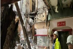 Image shows colleagues from Building Standards looking at the damaged building