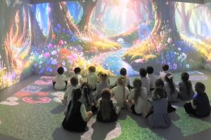 Image shows pupils sat in the immersive classroom with a 360 surround animation