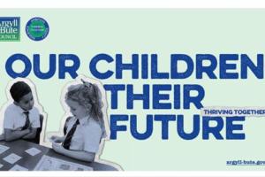 Image shows two school children at a desk talking to each other with the words our children their future next to them 