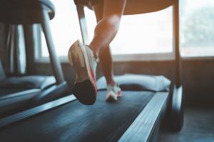 Image shows a woman's feet running on a treadmill