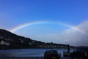 A picture of a rainbow over the town of Tarbert