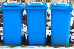 three blue wheelie bins