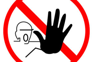 stop sign, person holding up hand