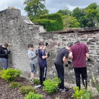 Pupils working on wall with lime and mortar 