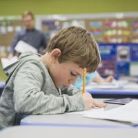 Boy working at a desk in a primary school