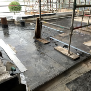 Temporary scaffold and roof trusses insitu. Vapour Control layer of felt